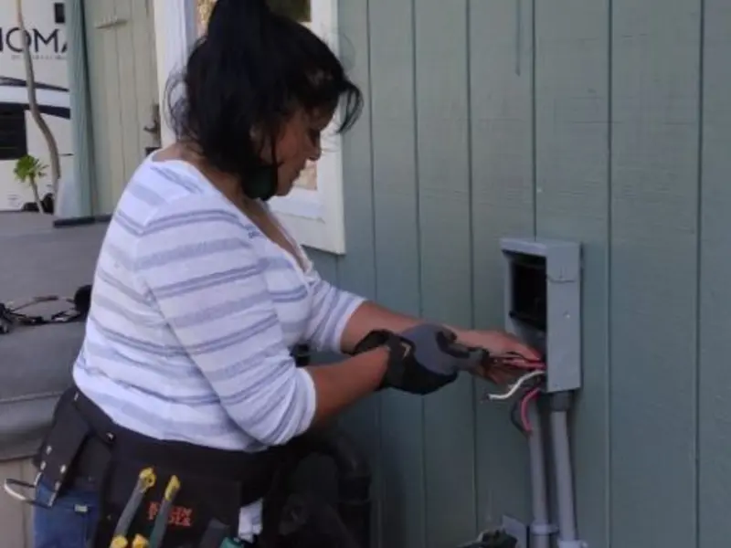 Licensed electrician wiring an exterior subpanel in Corinth
